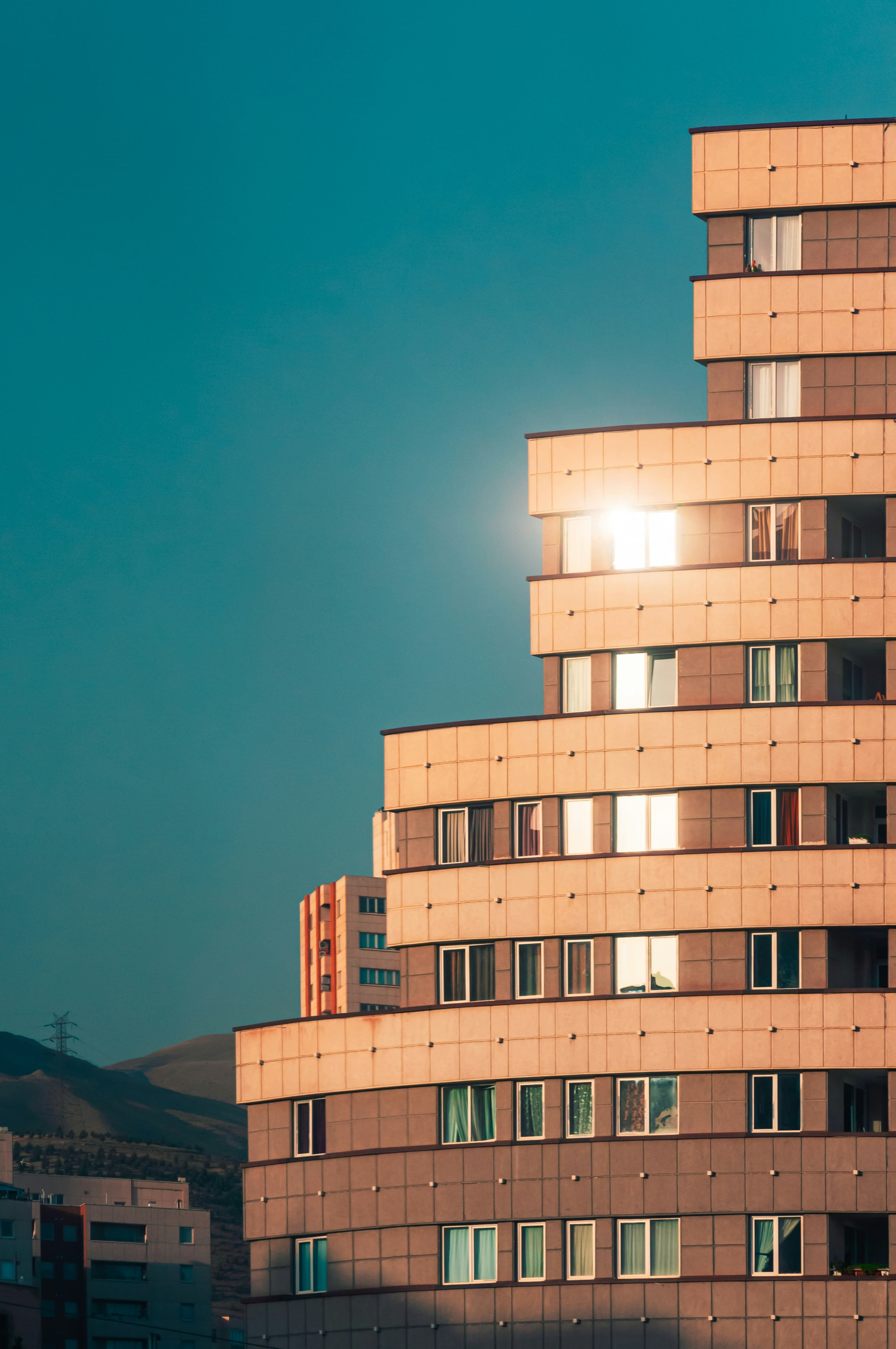 Stepped architectural facade in warm light against a deep blue sky